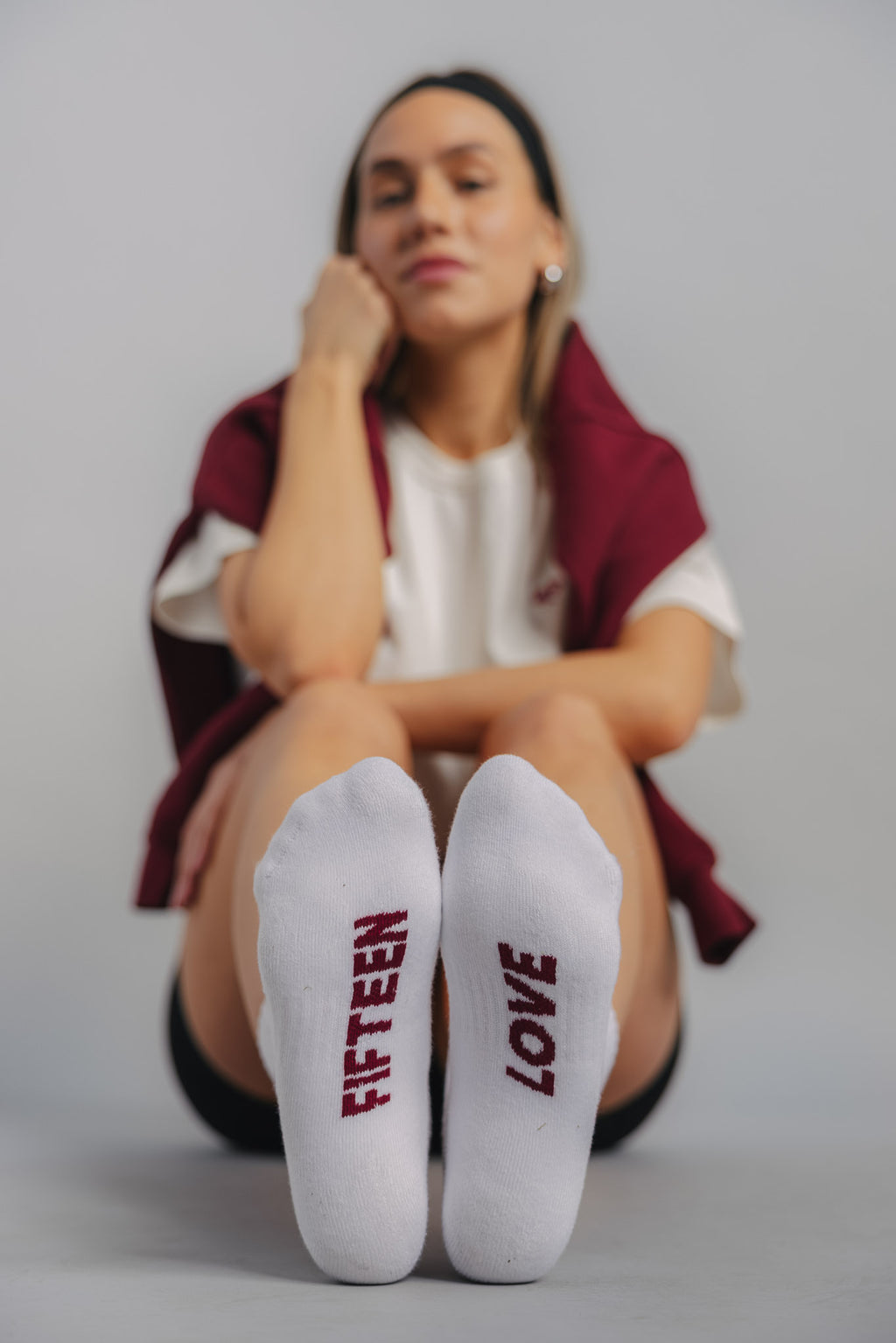 Front foot view of female tennis sock showing breathable fabric and heart racquet detail.